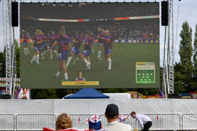 Football fans watch the match on the big screen. Photo: Tim Thursfield