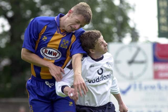 David Hughes competed for a header against Manchester United Ole Gunnar Solskjaer.