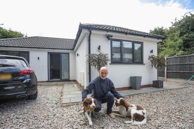 Mark Jones with his two dogs at their bungalow in Sutton Coldfield, West Midlands.