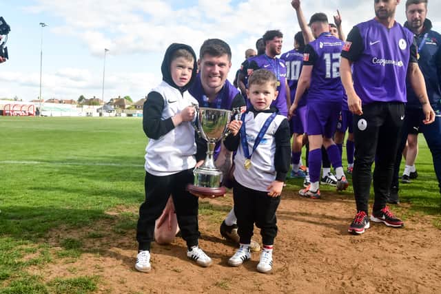 Record-breaking striker Matty Stenson lets his sons get their hands on the silverware (Picture: Kieren Griffin Photography)
