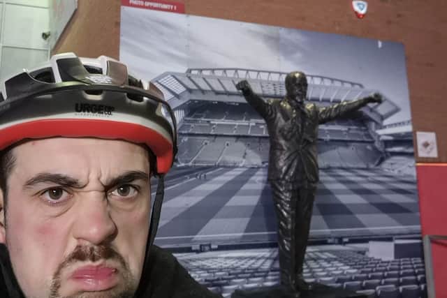 Stuart Bull, a Manchester United fan, grimaces outside Anfield