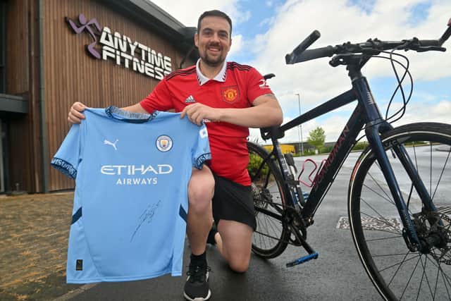 Stuart Bull has cycled to every Premier League stadium for charity. Manchester City gave him a shirt signed by Josko Gvardiol.