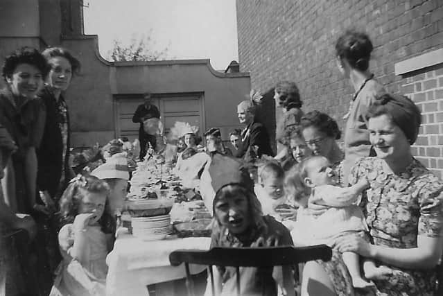 A party at the Prince of Wales, Bynner Street, Shrewsbury. The girl in the centre is thought to be Mary Yeomans, with her mother standing left with a Mrs Strain. 