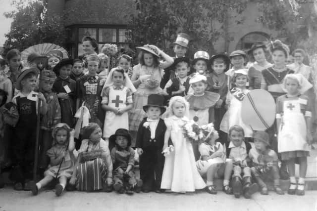 A street party to mark VE Day at Harlescott Close, later Roselyn, Shrewsbury. Glenys Richards. with the ribboned crook, played Bo-Peep, with front left, Michael Richards, and back, third from right in flat cap Peter Richards as Robin Hood. Also in picture is their father. Fred Richards, back row in top hat.