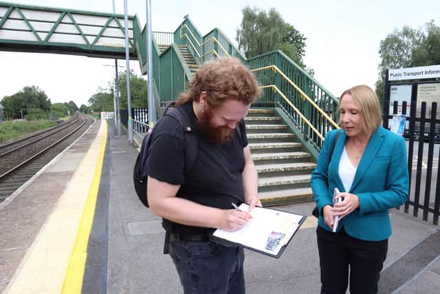 MP Helen Morgan petitioning residents in front of the steps at Whitchurch Station