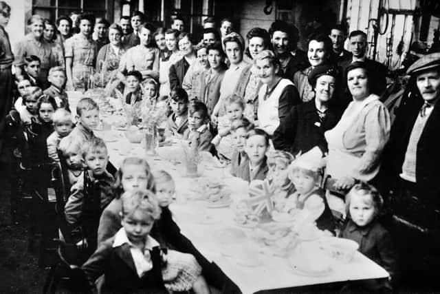 Newport's VE Day celebrations started in Springfield Terrace, before rain caused them to move to the garage in Stafford Road. Beryl Lawley, of Station Terrace, Newport, is on the left row of the table, second one in, with the bottom of her face obscured. Her brother Colin Lawley is on the right hand side of the table, seated at the far end.
