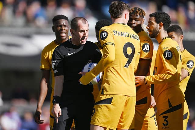 Match Referee Peter Bankes speaks to Rayan Ait-Nouri, Joergen Strand Larsen and Emmanuel Agbadou of Wolverhampton Wanderers after awarding an indirect free kick inside the Ipswich Town penalty area during the Premier League match between Ipswich Town FC and Wolverhampton Wanderers FC at Portman Road on April 05, 2025 in Ipswich, Englan. (Photo by Alex Broadway/Getty Images)