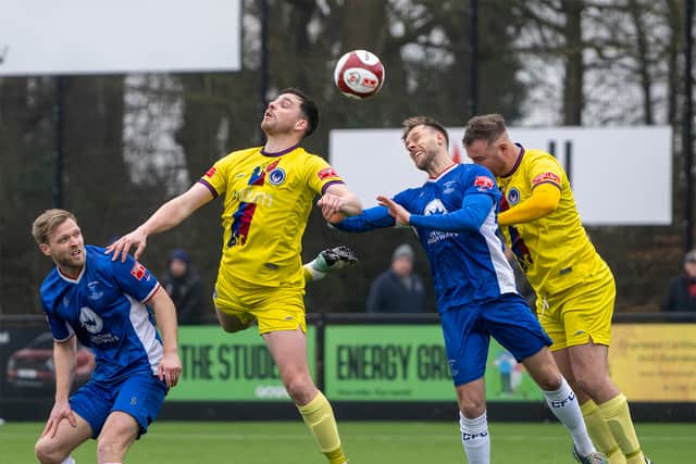 Chasetown in action. Mitch Clarke beaten to the header. Photo: Jim Wall