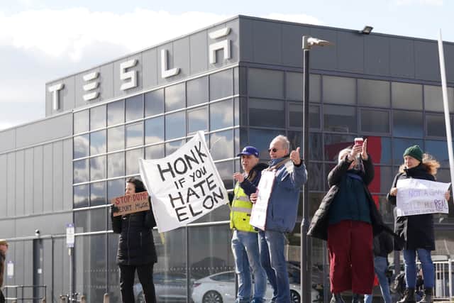 A small group of protesters gathered at a Tesla dealer, where they called on people to boycott Elon Musk’s electric car maker