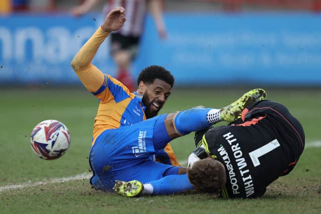 Vadaine Oliver of Shrewsbury Town challenges Joe Whitworth of Exeter City for the ball