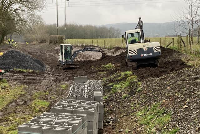 Work continues to profile the channel where it widens on a bend.