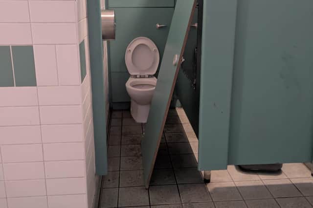 A cubicle door was smashed down.