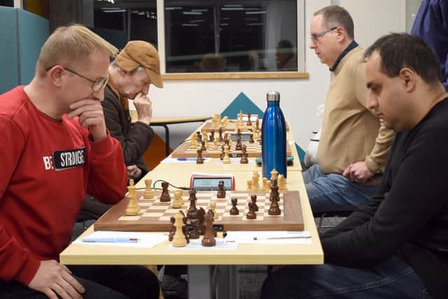 Tomasz Sygnowski of Wolverhampton chess club, left, clashes with Shabir Okhai in the decisive final round.