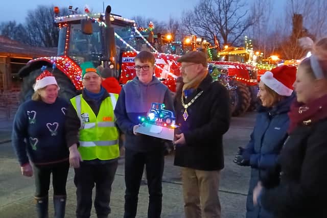 Ben Edwards with the trophy for best illuminated tractor, from left: Sue Roberts, Dave Roberts, Ben Edwards, Mayor Councilor Mike Isherwood, MP Helen Morgan and Lady Mayoress Jem Isherwood. Picture: Mike Lade