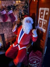 Santa in his grotto in Builth Wells previously, greeting youngsters and giving them a gift