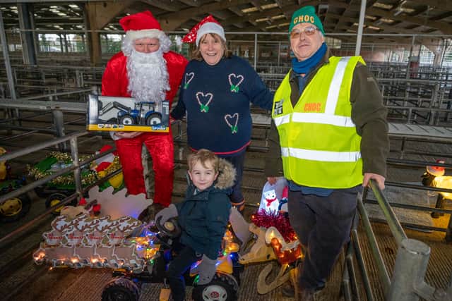 Reign aged three with Santa, Sue Roberts and Dave Roberts as winner of best illuminated ride-on toy. Picture: Graham Mitchel