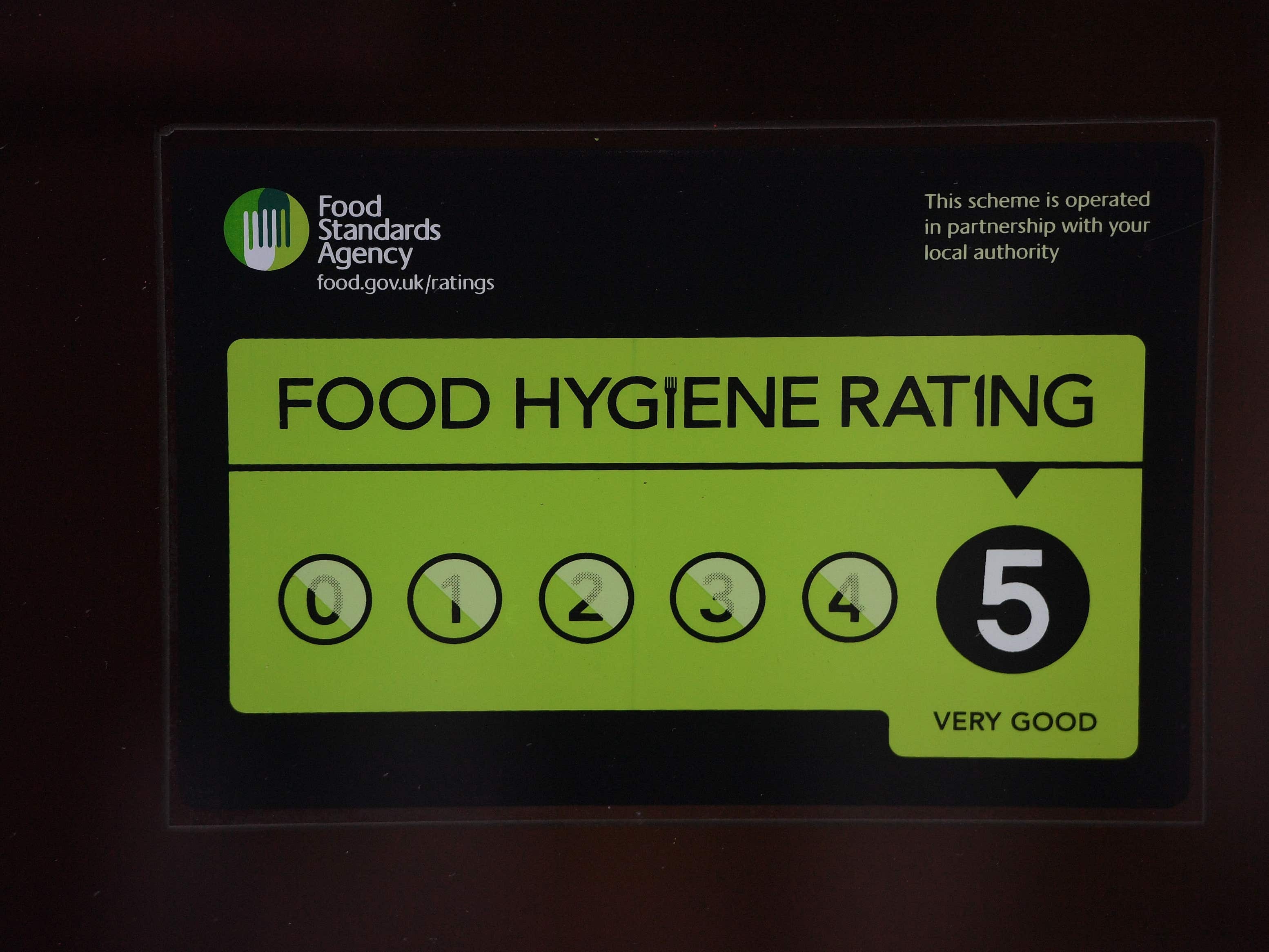 A Food Standards Agency rating sticker on a window of a restaurant