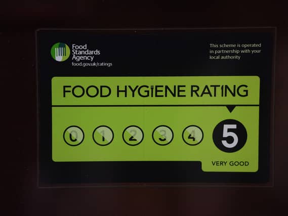 A Food Standards Agency rating sticker on a window of a restaurant