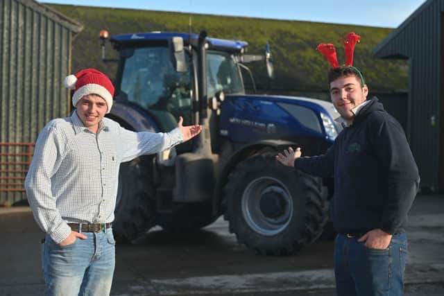 Tom Wellings (in the cheque) and Josh Barratt, founders of the Christmas Tractor Run in Bridgnorth