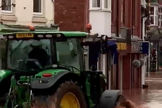 A man in a tractor driving down Tenbury Wells