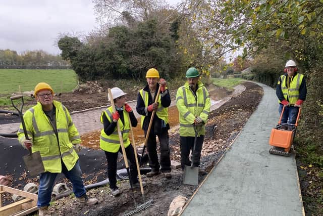 Volunteers celebrate the original scope completion - five months ahead of schedule.