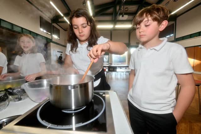 Layla Pope and Henry Gardiner, both nine, keep an eye on the food