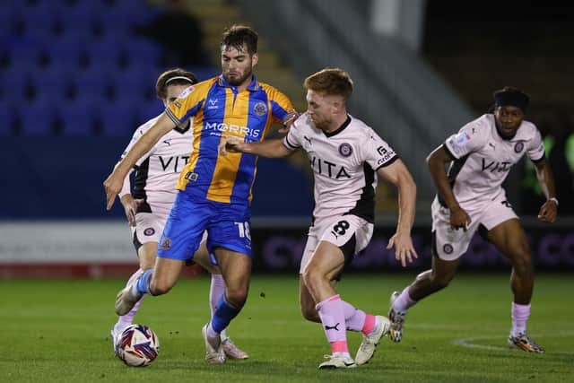 Tom Bloxham of Shrewsbury Town and Callum Camps of Stockport County (AMA)