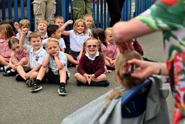 Mikey's classmates watched on and cheered as his hair was shaved 