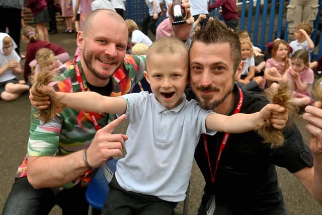 Mikey Robinson had his hair shaved off by Alex Taylor of Taylor's Barbers in Bridgnorth, and watching on was Dad Keith Robinson