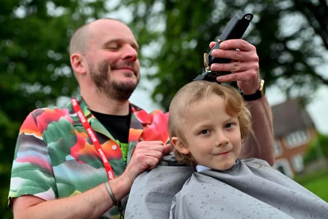 Alex Taylor from Taylor's of Bridgnorth barbers shaved Mikey's head at St Leonards Primary School 