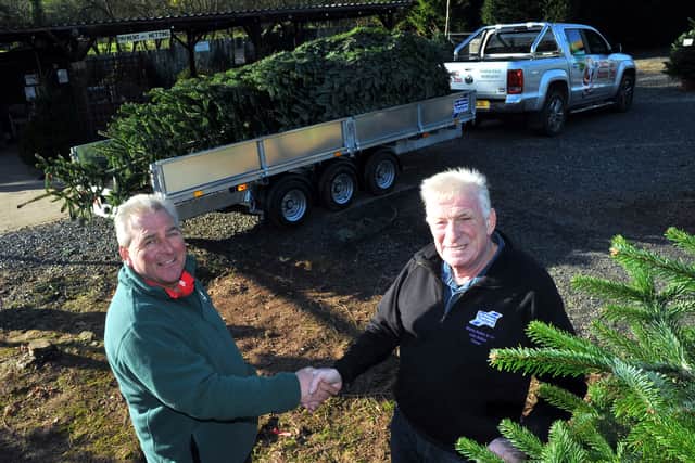 Back in 2014, Morris Bufton & Co provided the trailer to take a Christmas tree to 10 Downing Street – pictured are Colin Griffith of Dinmore Hill Christmas Trees and John Bufton.