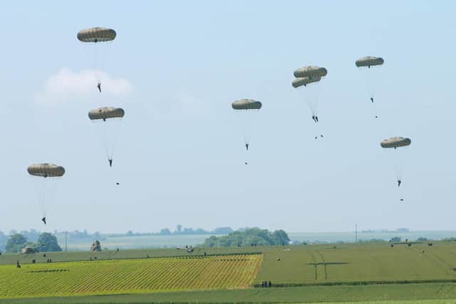 Members of the Parachute Regiment jump into fields in Ranville, Normandy, in 2004 recreating the events of the D-Day invasion in 1944