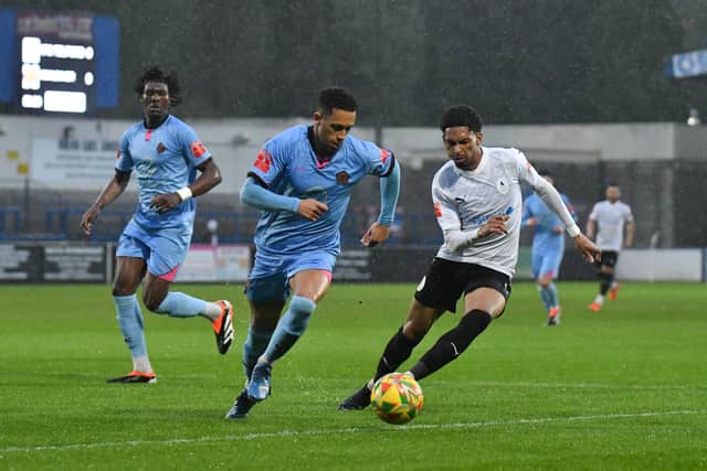 Ricardo Dinanga (AFC Telford United Midfielder)  pressures Mickleover’s defender Jake Bennett on the edge of the box (pic Kieren Griffin)