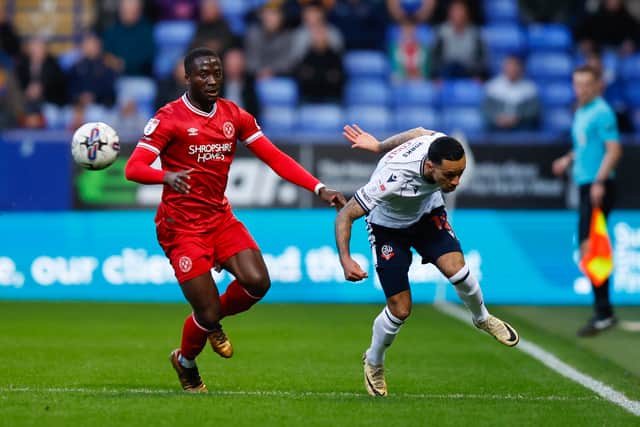 Dan Udoh of Shrewsbury Town and Josh Dacres-Cogley of Bolton Wanderers.