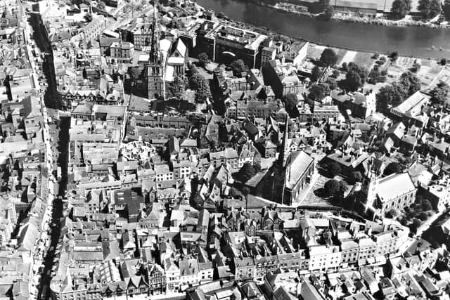 This aerial image shows Shrewsbury town centre in the 1950s. St Mary's Church, St Alkmund's Church, and St Julian's Church are all in the picture as is a busy Pride Hill on the left.