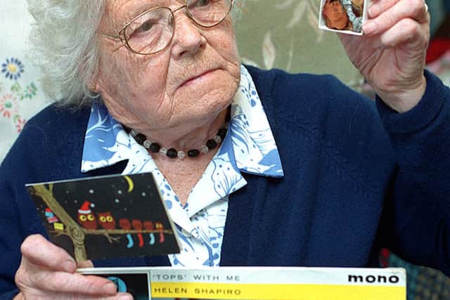 Mary Bray in 1999 with the rose and carnation from Frankie Vaughan and Helen Shapiro's album gift.
