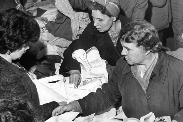 1962 - The rush is on, and there are bargains galore at the Codsall Roman Catholic Church jumble sale held at the Crown Hotel, Codsall.