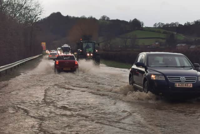 Traffic pushing through standing water on the Welshpool-Shrewsbury road on Tuesday afternoon. Photo: Barry Evans