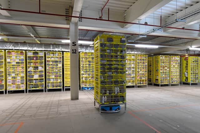 An Amazon robot moves a shelf around