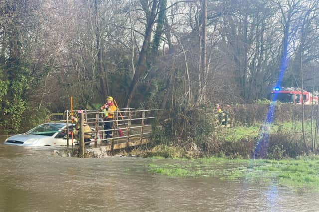 The partially submerged car.
