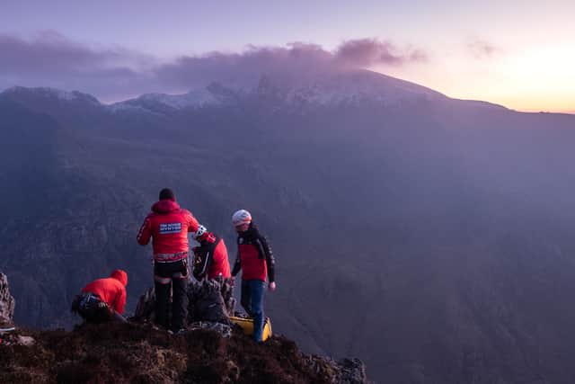 MRT_Member_Esgair Felen.jpeg – “Llanberis Mountain Rescue Team member preparing to get lowered and rescue 2 stuck scramblers on Esgair Felen”. Photo : J Kiernan
