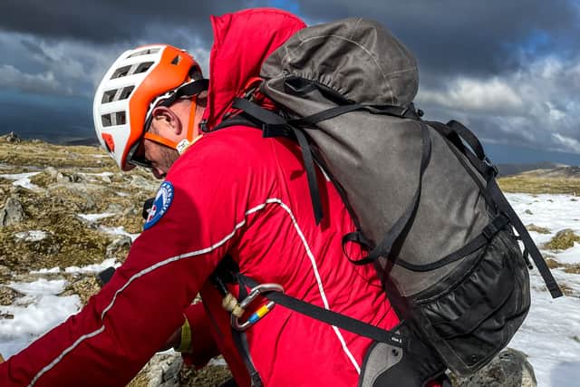 Heli drops off team member – “Llanberis Mountain Rescue Team member after being dropped off by Rescue 936 on the summit of Carnedd Ugain”. Photo: J Kiernan