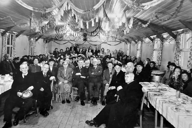 nostalgia pic. Trench. A picture taken at the old Trench community centre or community hall. It was on the Trench Road. This picture is from John Latham, 618362, Hope Dene, off Church Road, Woodhouse Crescent, Trench. Date of birth: December 17, 1928. He thinks it was taken in about 1947. If so the decoration would suggest it is Christmas 1947. He is on the picture somewhere at the back. 'This is the old people of Trench. (It) was on the main Trench Road. If you know where the Dun Cow is, just past the Dun Cow used to be the Co-op supermarket. It was on the opposite side of the road. It is not there now." Picture copied by freelance Toby Neal on Tuesday March 1, 2022, at Mr Latham's house with his permission. The print has the Wellington Journal and Shrewsbury News copyright stamp. Trench community hall. Library code: Trench nostalgia 2022..