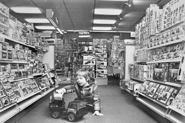 nostalgia pic. Shrewsbury. 'Marcus McDonald, aged four, of Shrewsbury, finds just what he would like for Christmas in the toy department of the town's John Menzies store.' This is a print in the Shropshire Star picture archive and was taken on November 21, 1980. The print has the Shropshire Star copyright stamp. The photographer's name is illegible but begins with D and might be 'Dave'. Toys. Toy shop. Library code: Shrewsbury nostalgia 2020..