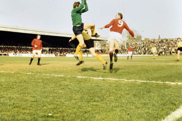 Jack Bentley challenges Barnet goalie Jack McClelland.
