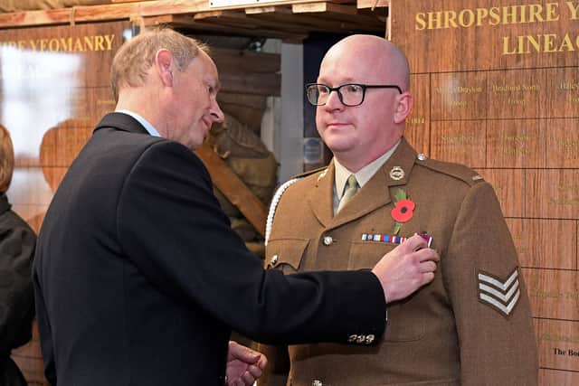 The Duke of Edinburgh presents a Long Service Good Conduct award to Sergeant Joel Edwards.