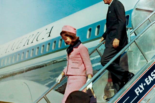 President John F. Kennedy and first lady Jacqueline Bouvier Kennedy walk down the steps of Air Force One as they arrive at Love Field in Dallas, Texas less than an hour before his assasination in this November 22, 1963 photo by White House photographer Cecil Stoughton obtained from the John F. Kennedy Presidential Library in Boston. 
