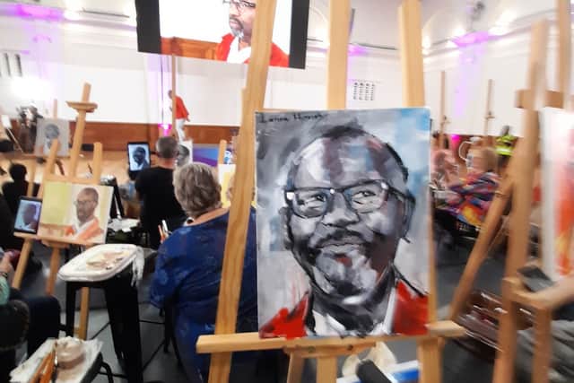Beverley's portrait of Sir Lenny with the comedian sitting in the background