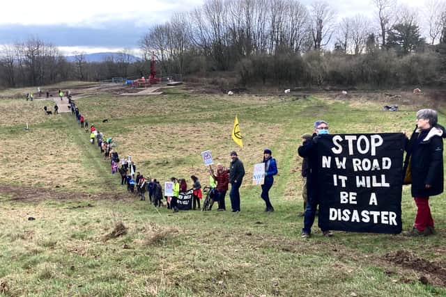Protestors line the road of the proposed relief road in an early demonstration