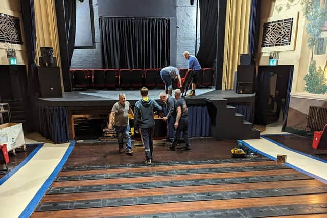 Volunteers moving seating at the Regal, Tenbury